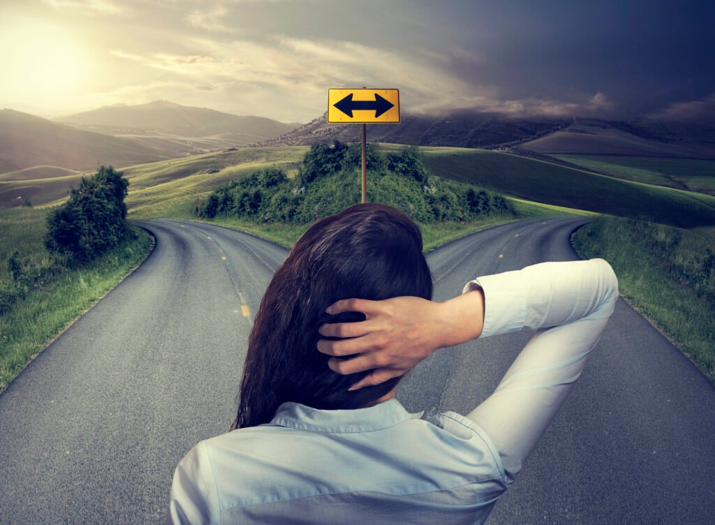 A woman looking down a fork in the road